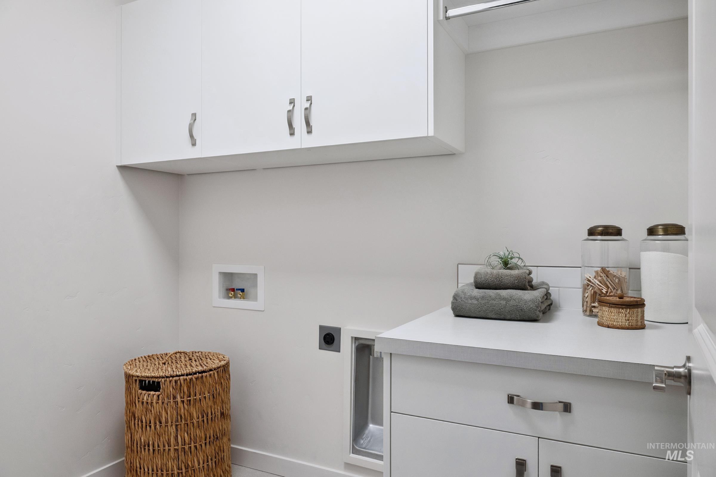 Laundry area featuring cabinet space, hookup for an electric dryer, and hookup for a washing machine