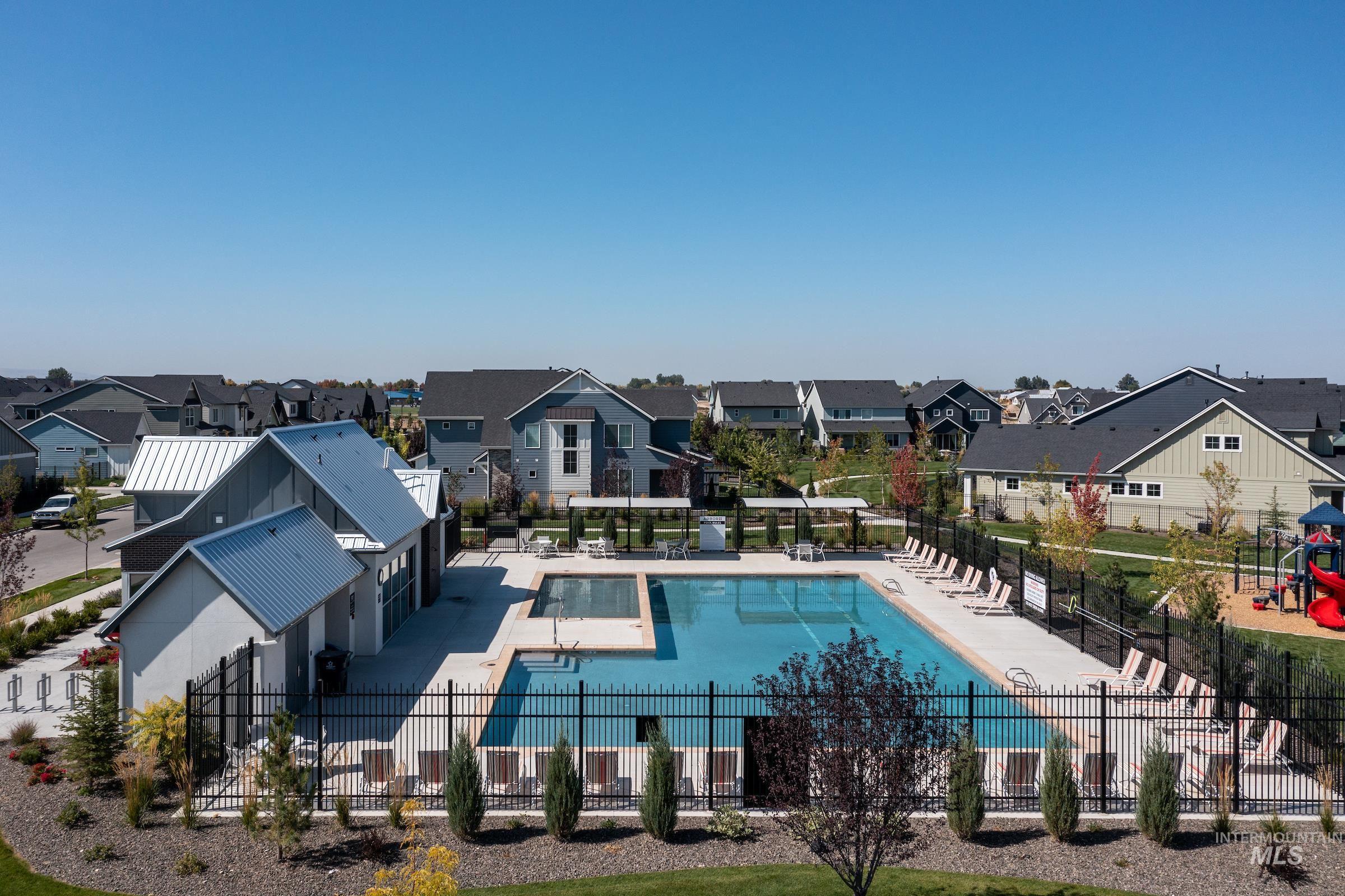 Community pool featuring a patio and a residential view