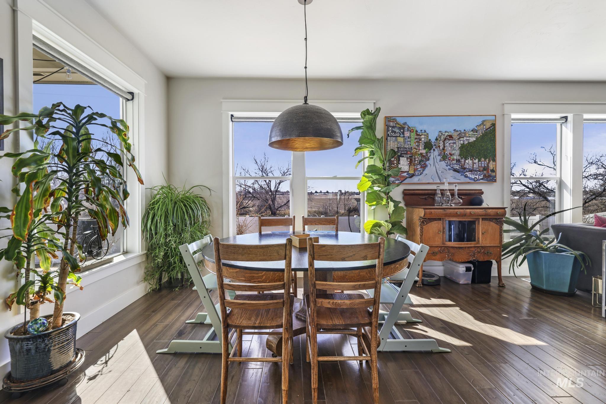 Dining area featuring dark wood-type flooring and baseboards