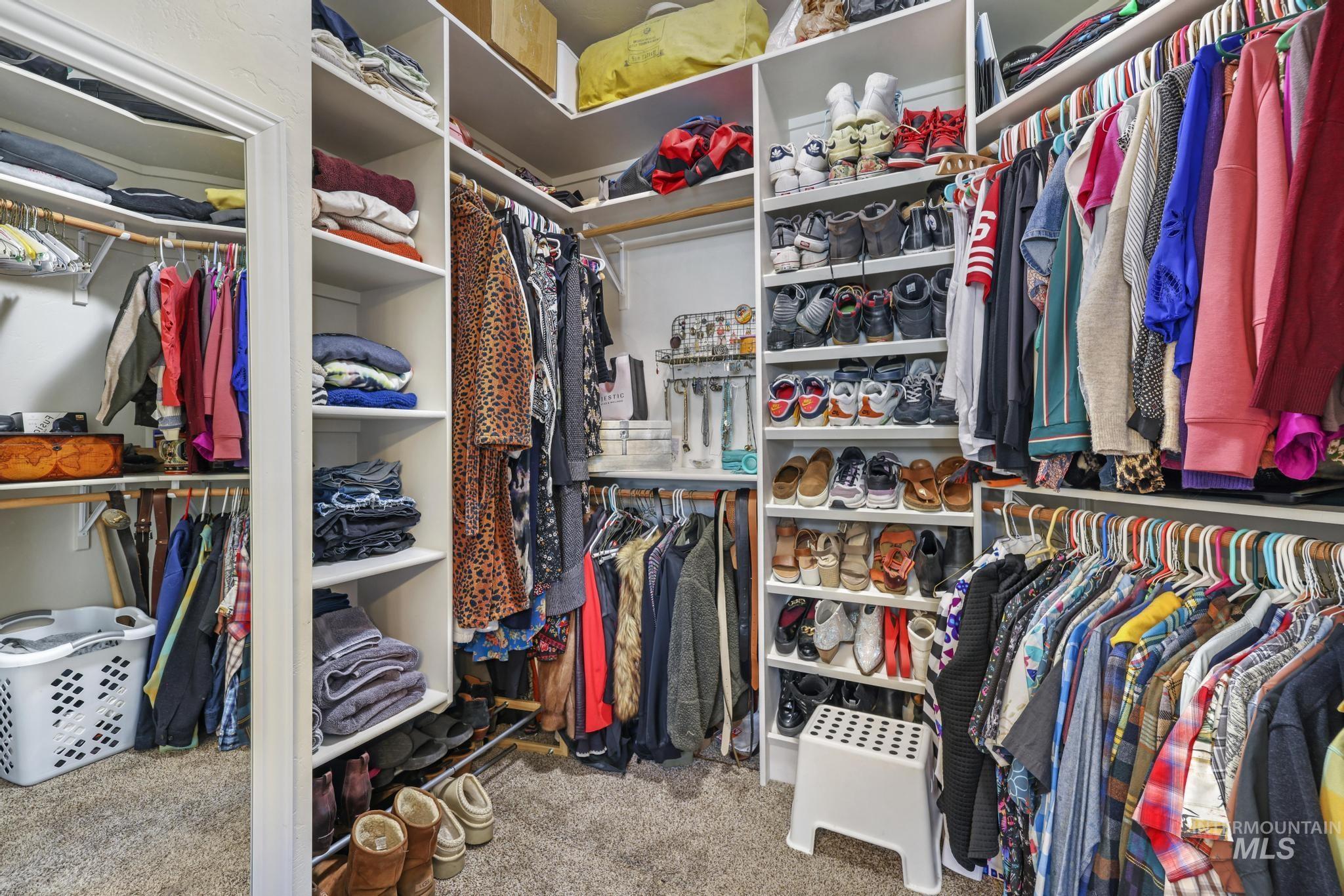 Walk in closet featuring light carpet