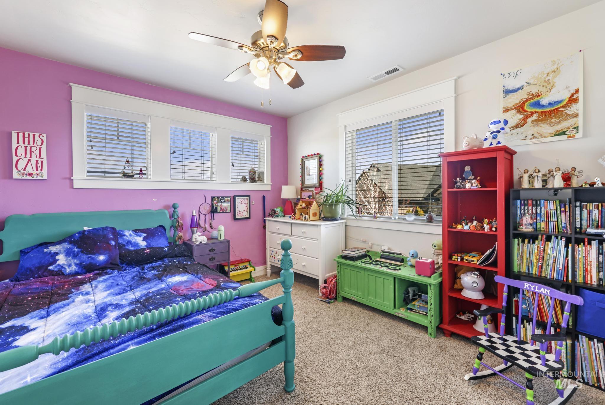 Bedroom featuring light carpet and a ceiling fan