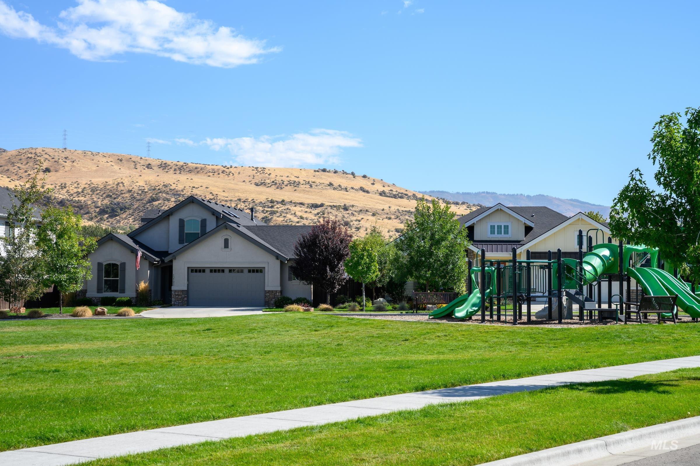 Communal playground featuring a yard and a mountain view