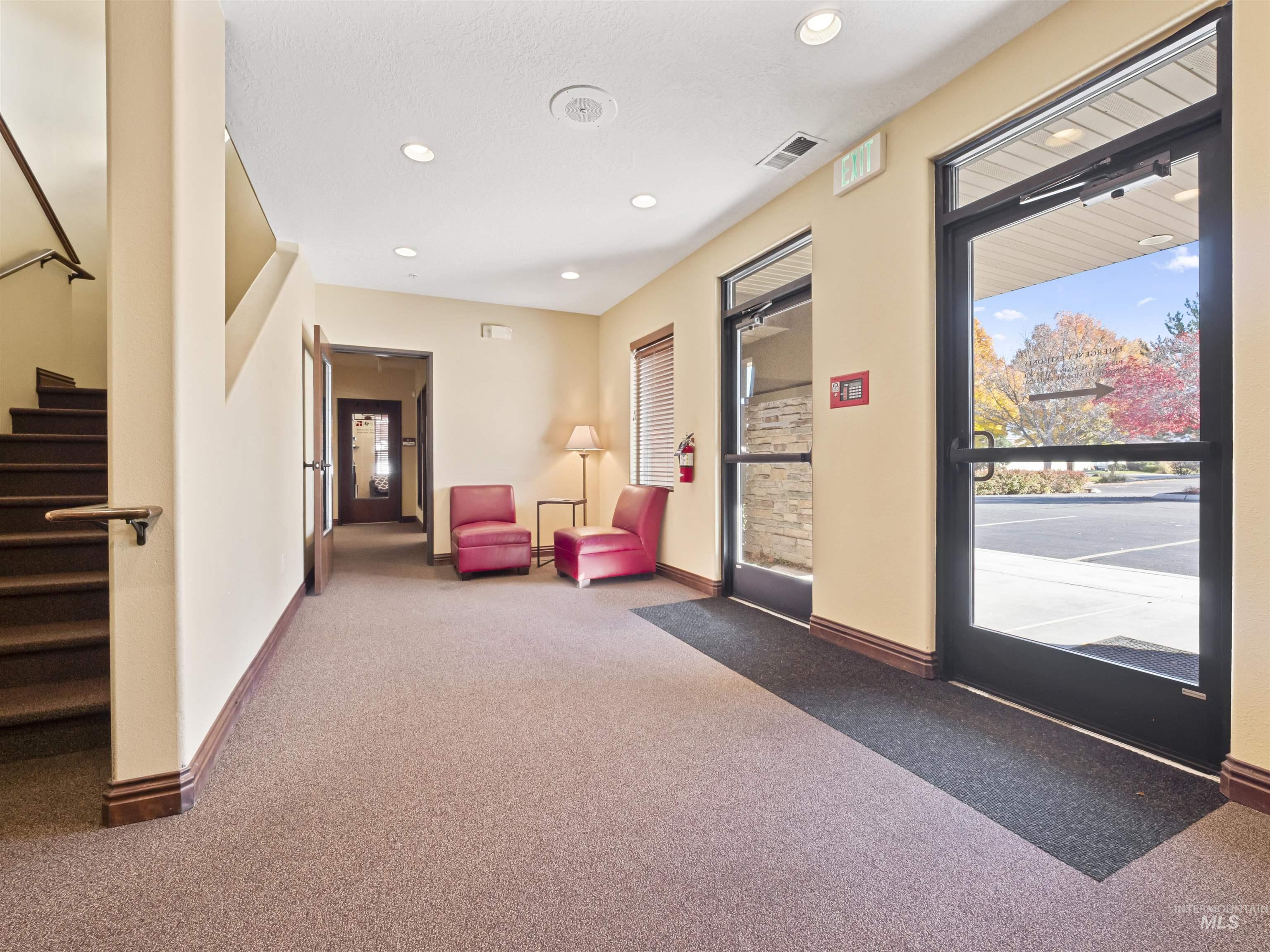 Community lobby featuring stairs and recessed lighting