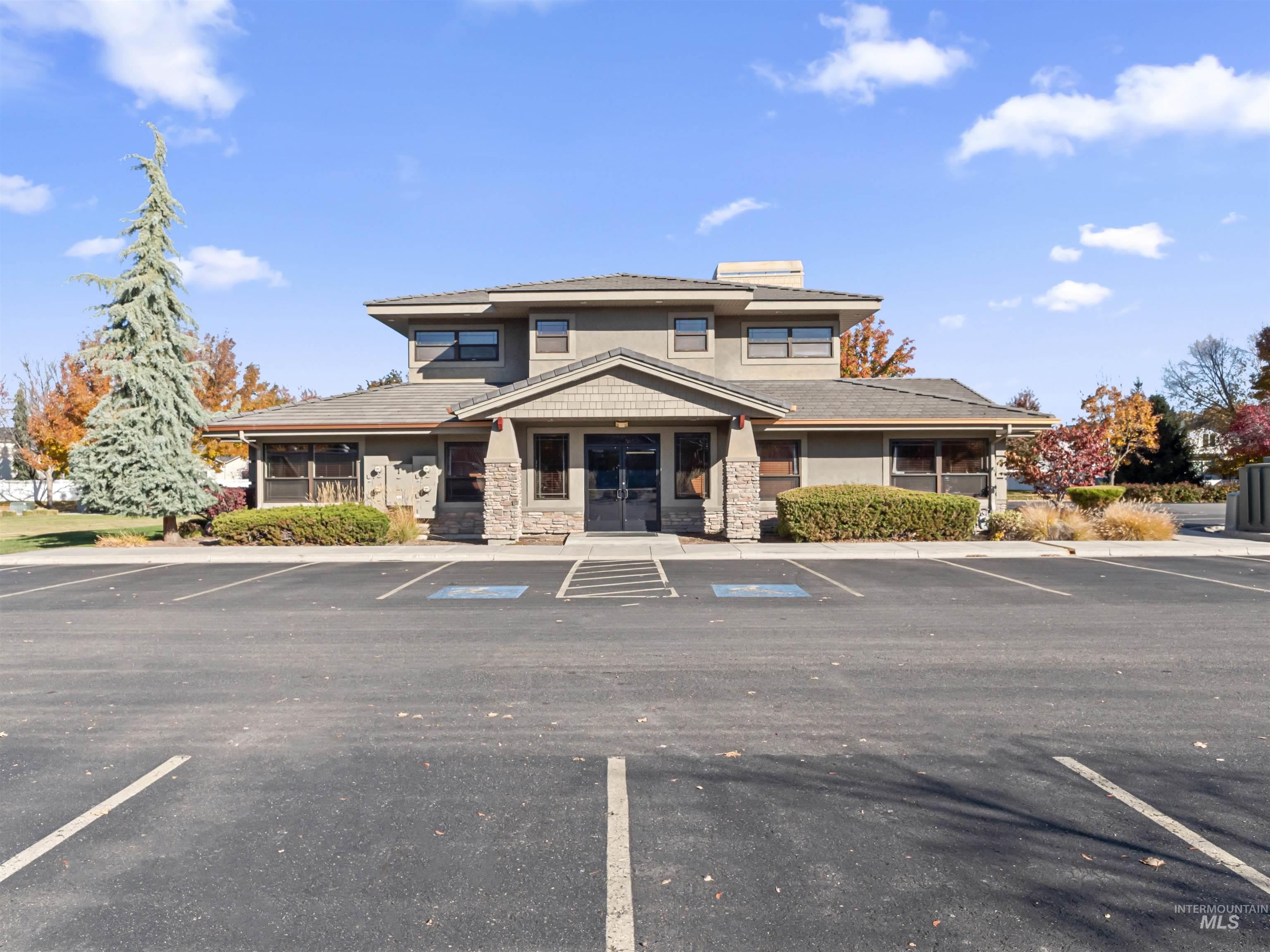 View of building exterior featuring uncovered parking