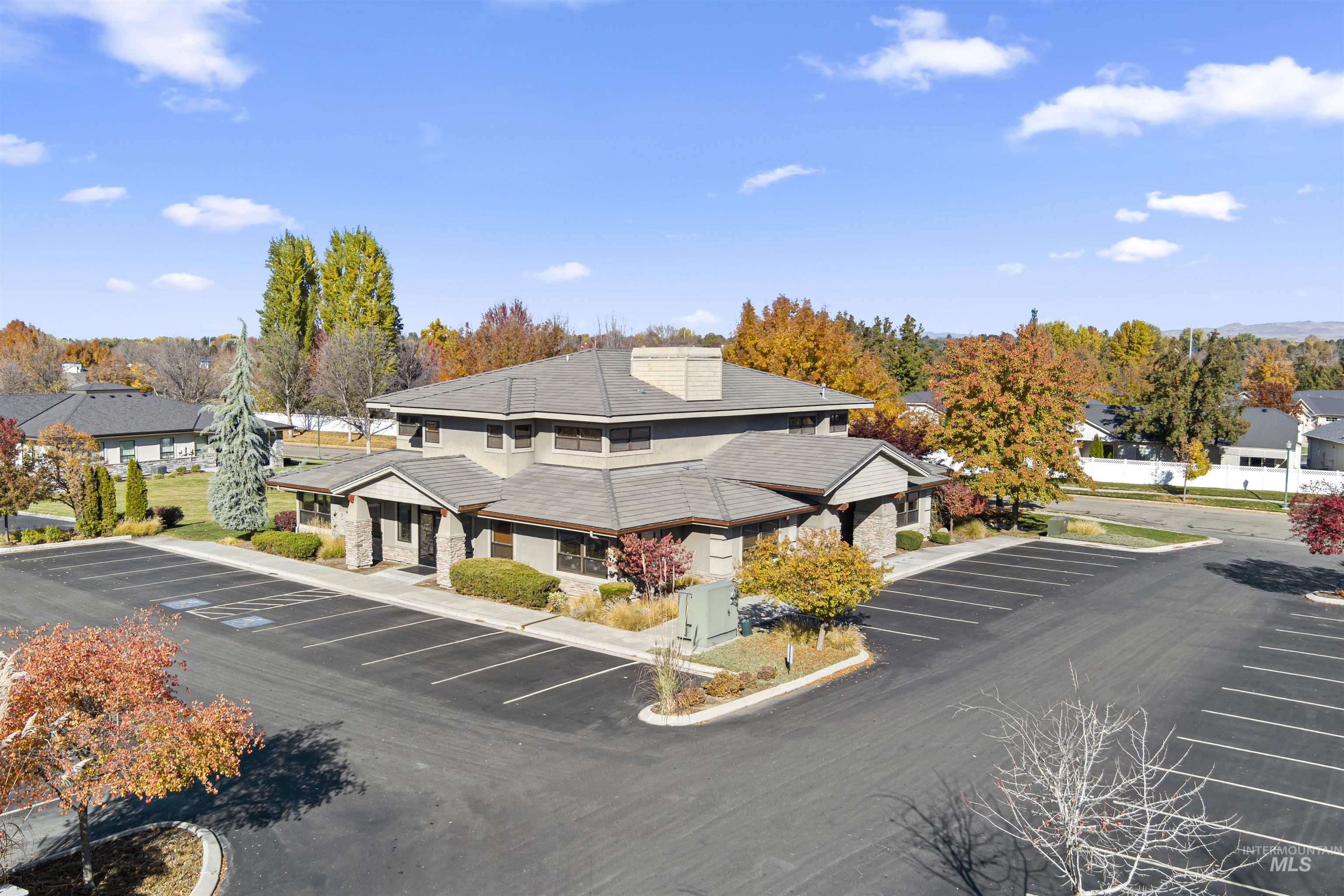 View of building exterior with uncovered parking