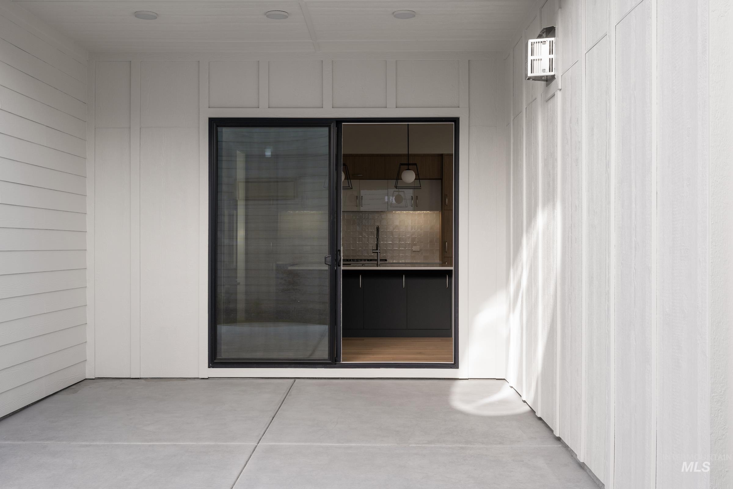 View of exterior entry with a patio