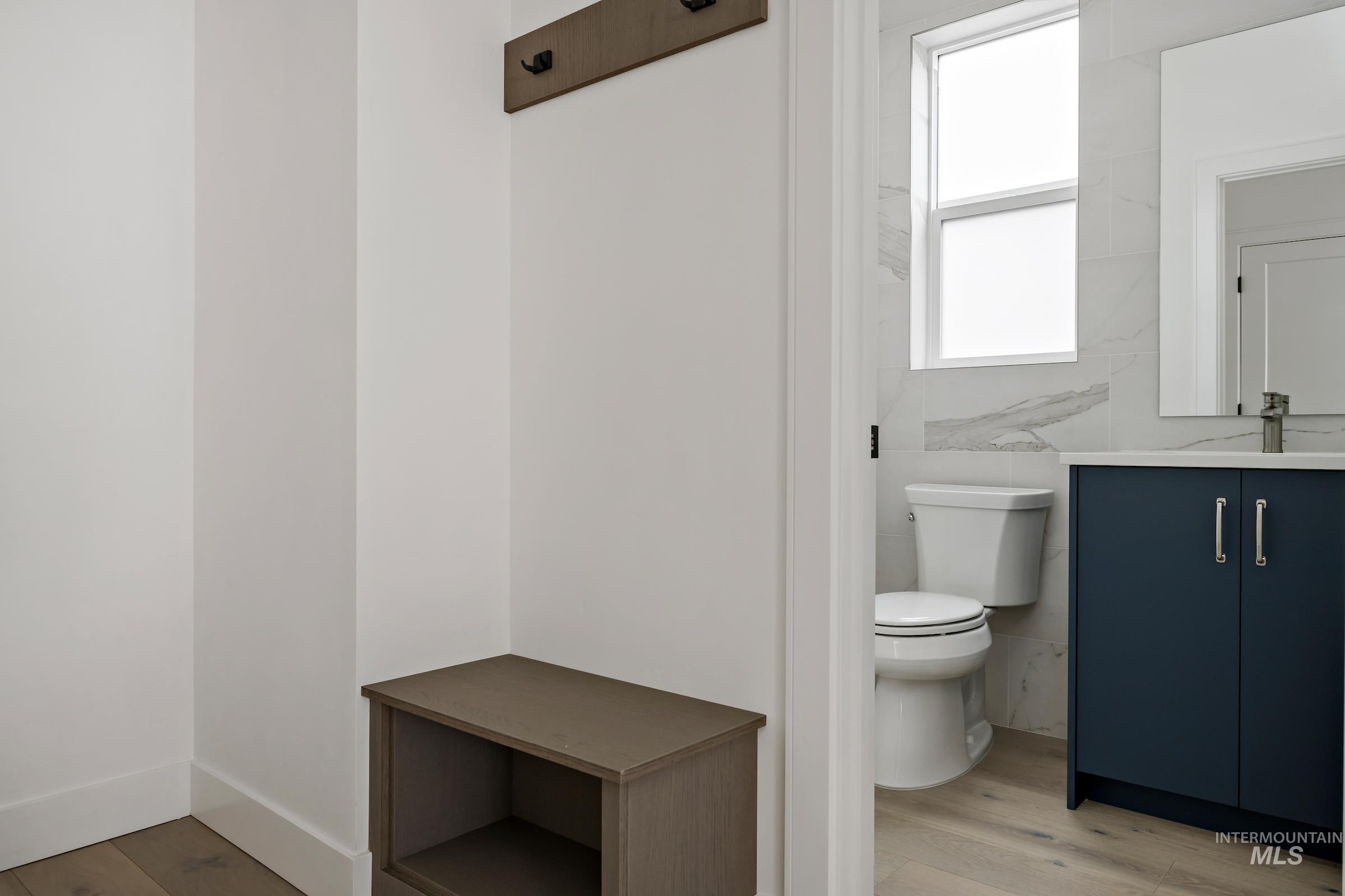 Half bathroom featuring light wood finished floors and vanity