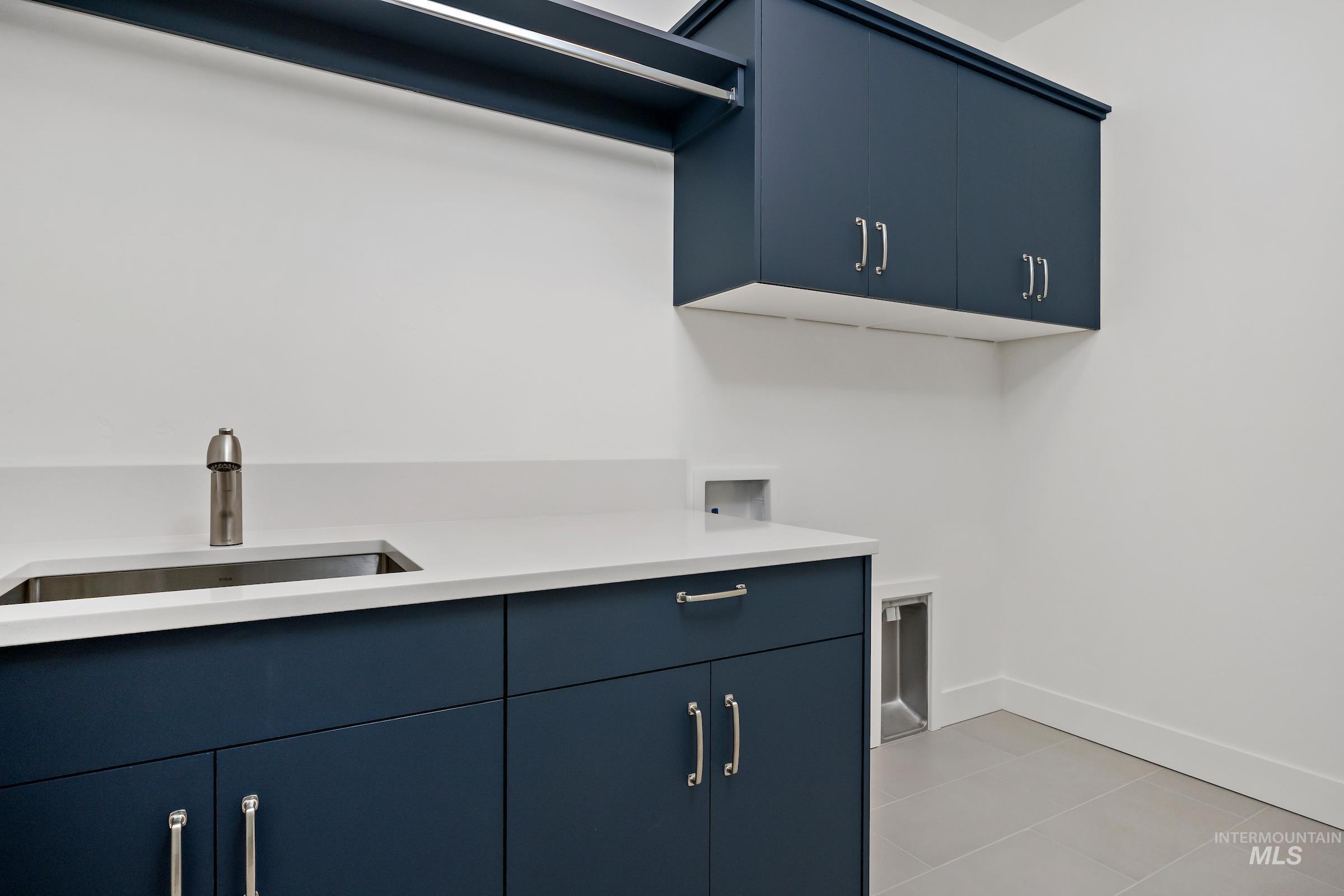 Laundry room featuring cabinet space, light tile patterned flooring, and hookup for a washing machine