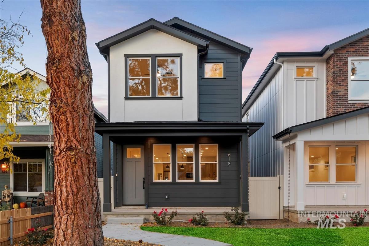 Contemporary house featuring board and batten siding and a gate
