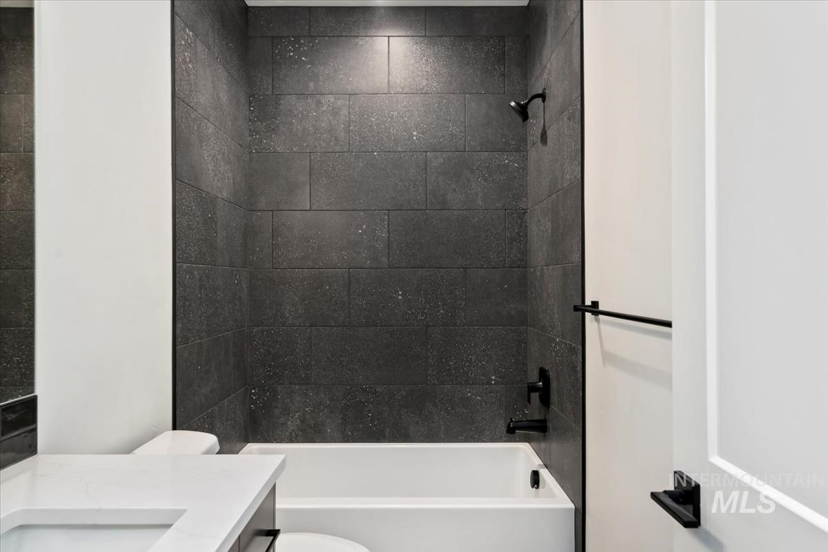 Bathroom featuring bathing tub / shower combination and vanity