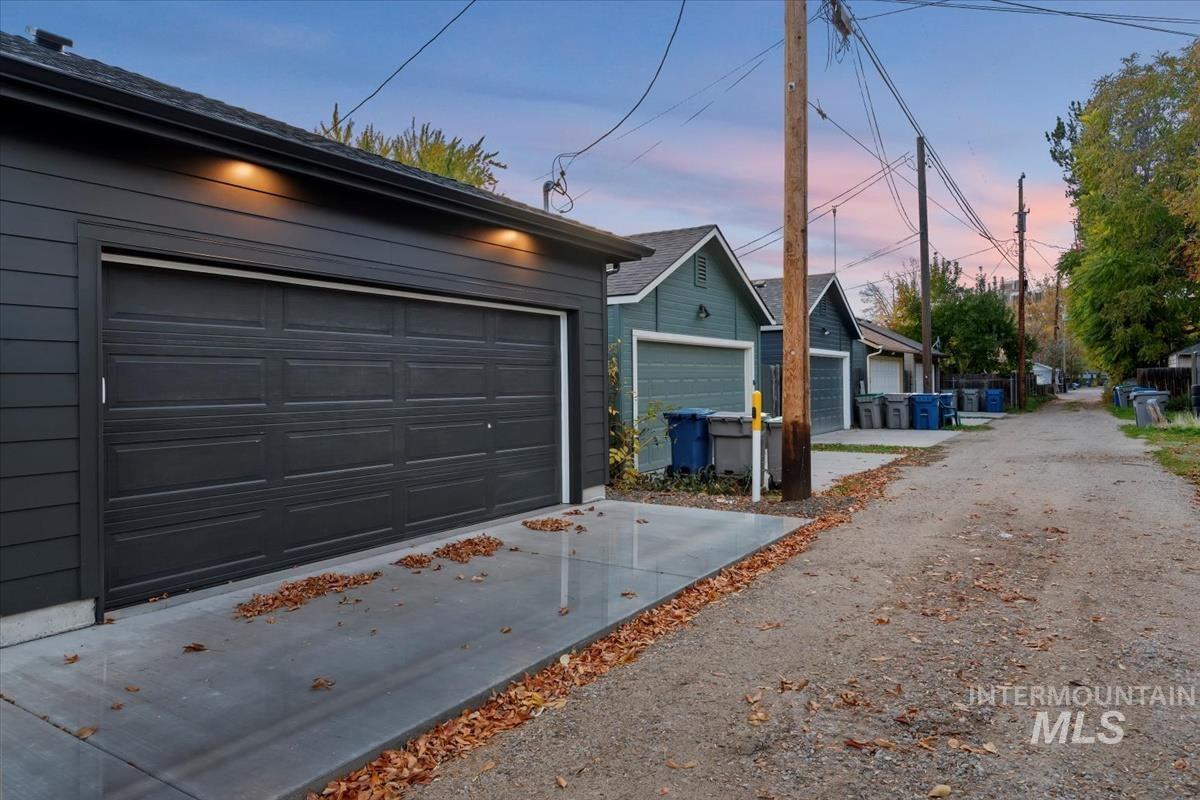 Garage at dusk featuring driveway