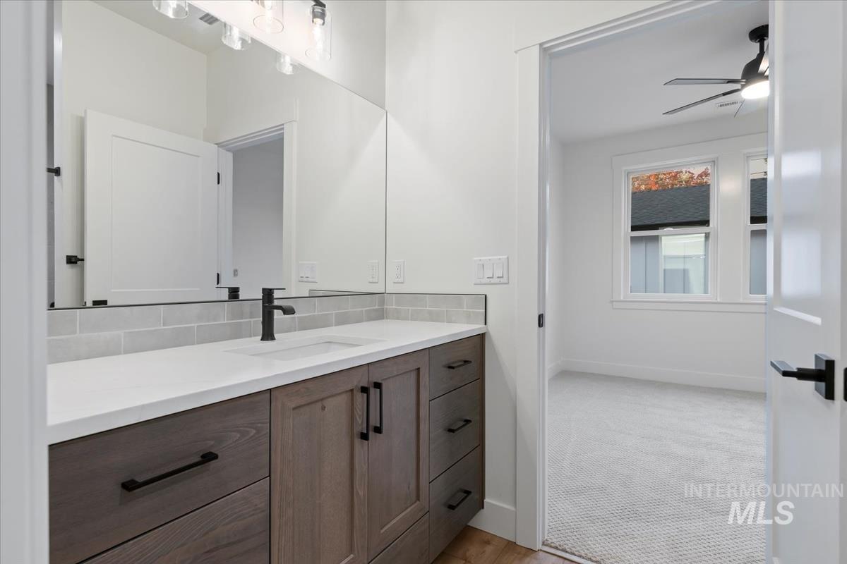 Bathroom featuring vanity and ceiling fan
