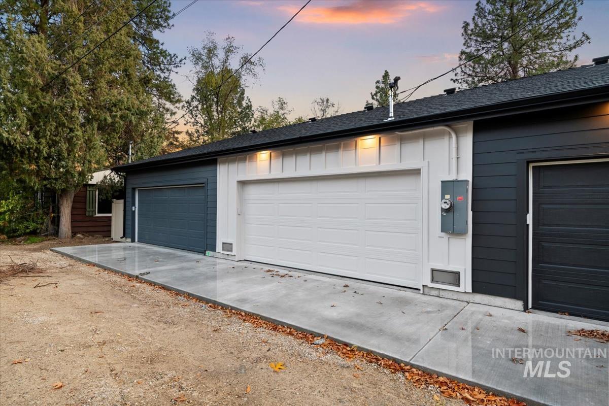 View of garage at dusk