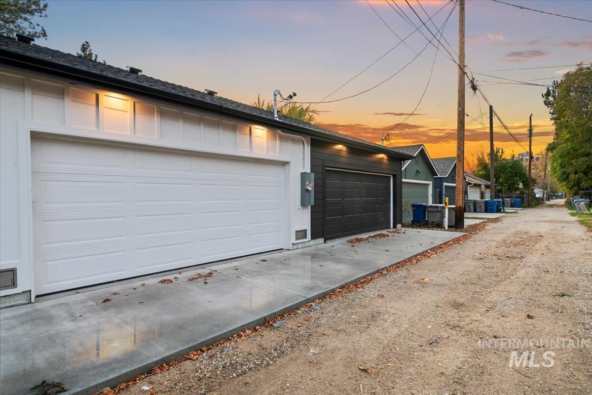 View of garage at dusk