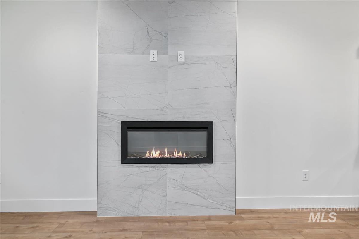 Detailed view of wood finished floors and a fireplace