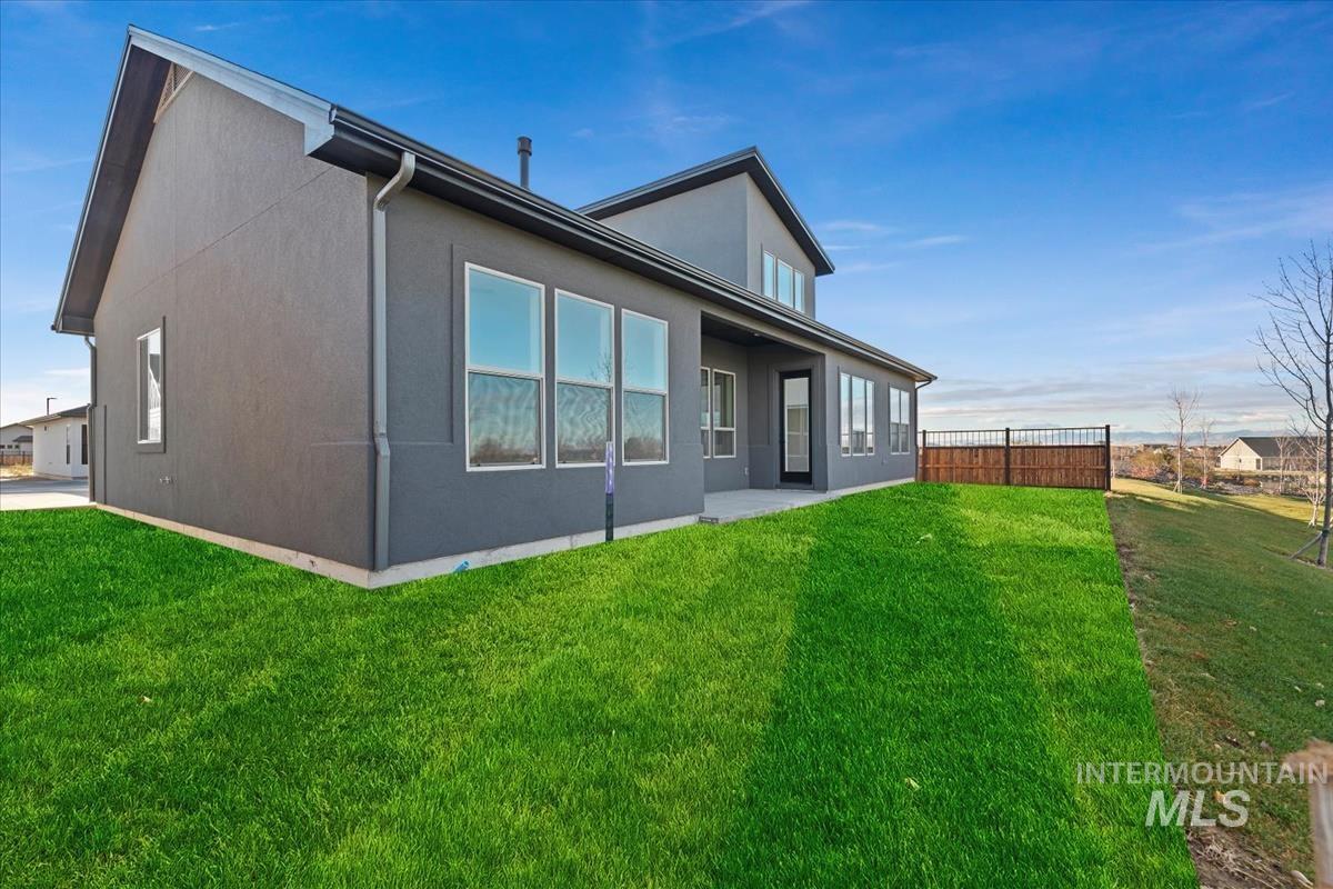 Rear view of property featuring a patio area and stucco siding