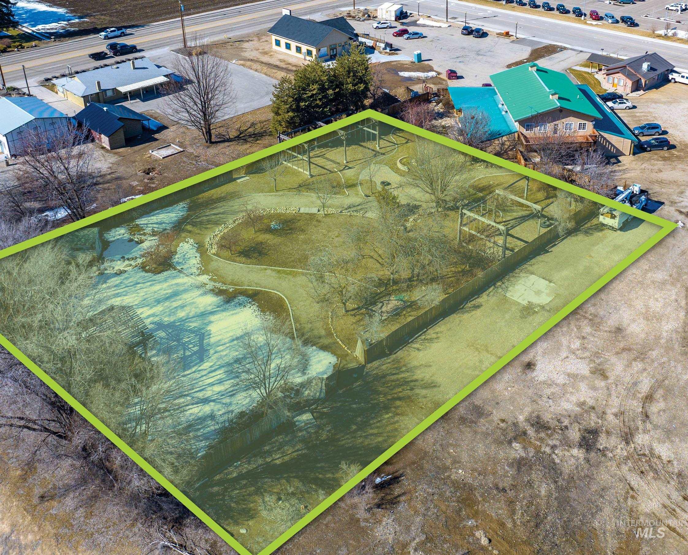 Aerial view of property and surrounding area with property parcel outlined