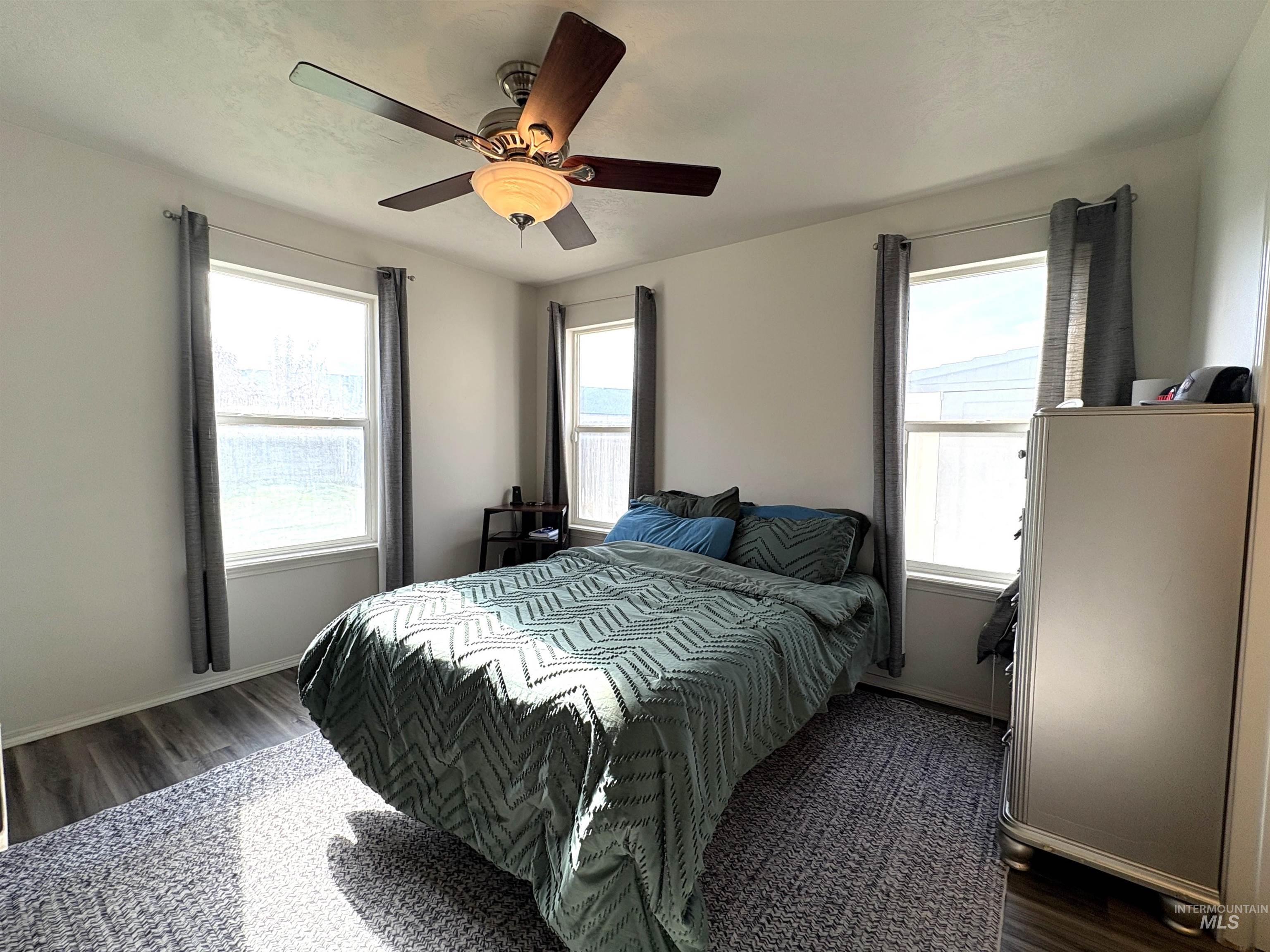 Bedroom with wood finished floors and ceiling fan