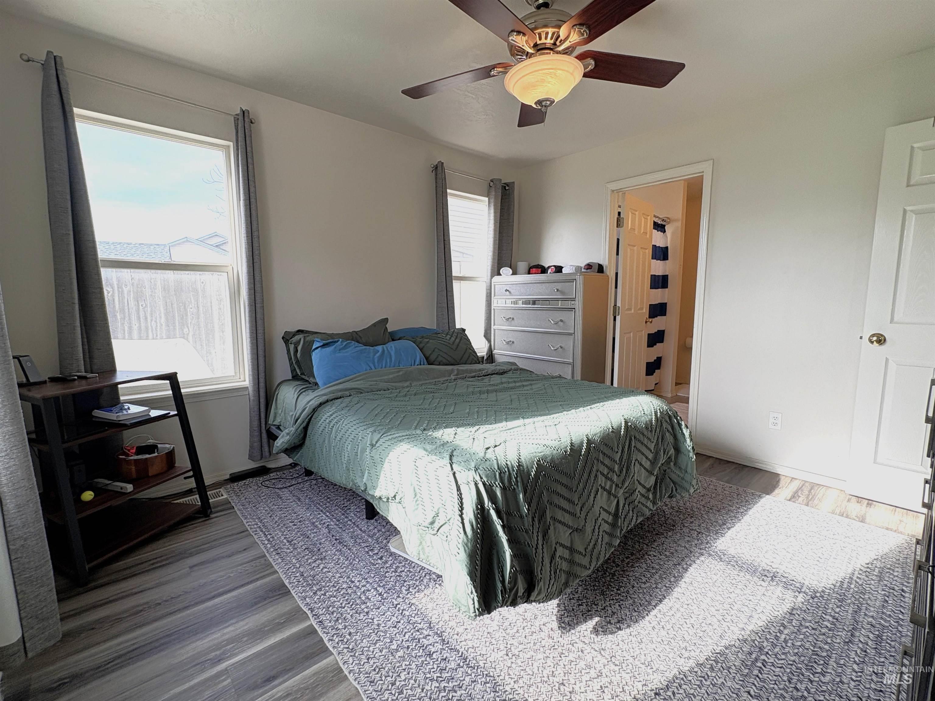 Bedroom featuring wood finished floors and ceiling fan
