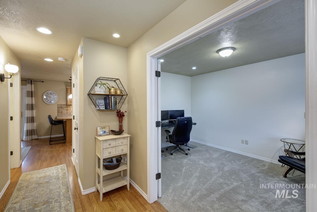 Office featuring light wood-type flooring and recessed lighting