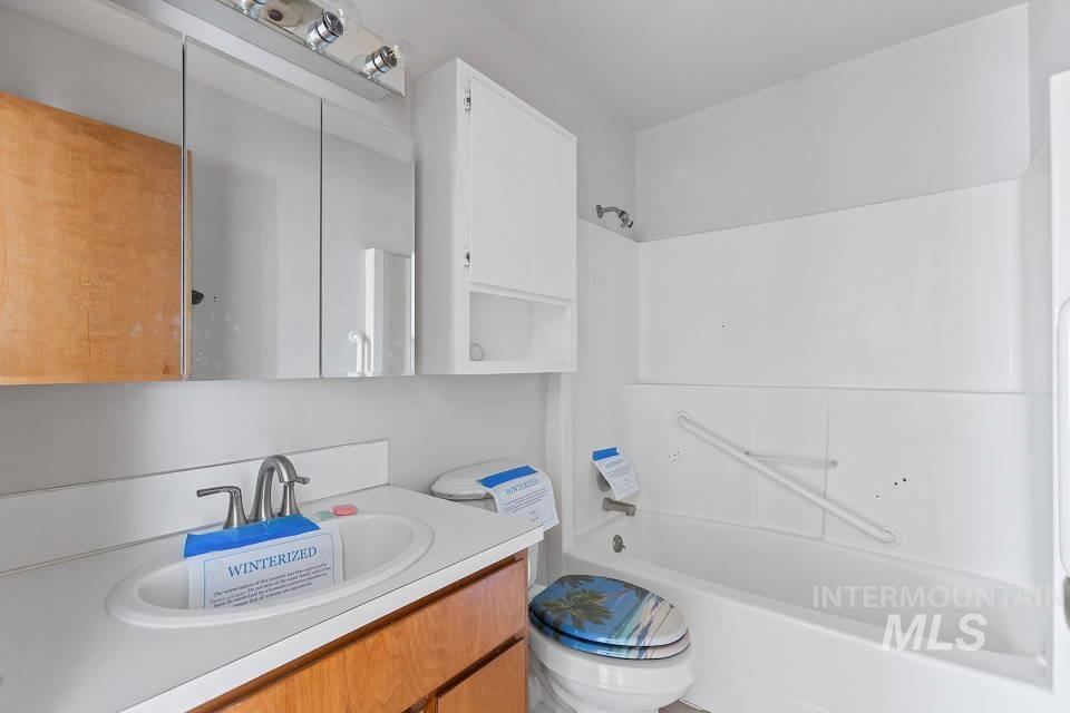 Full bath featuring vanity and  shower combination