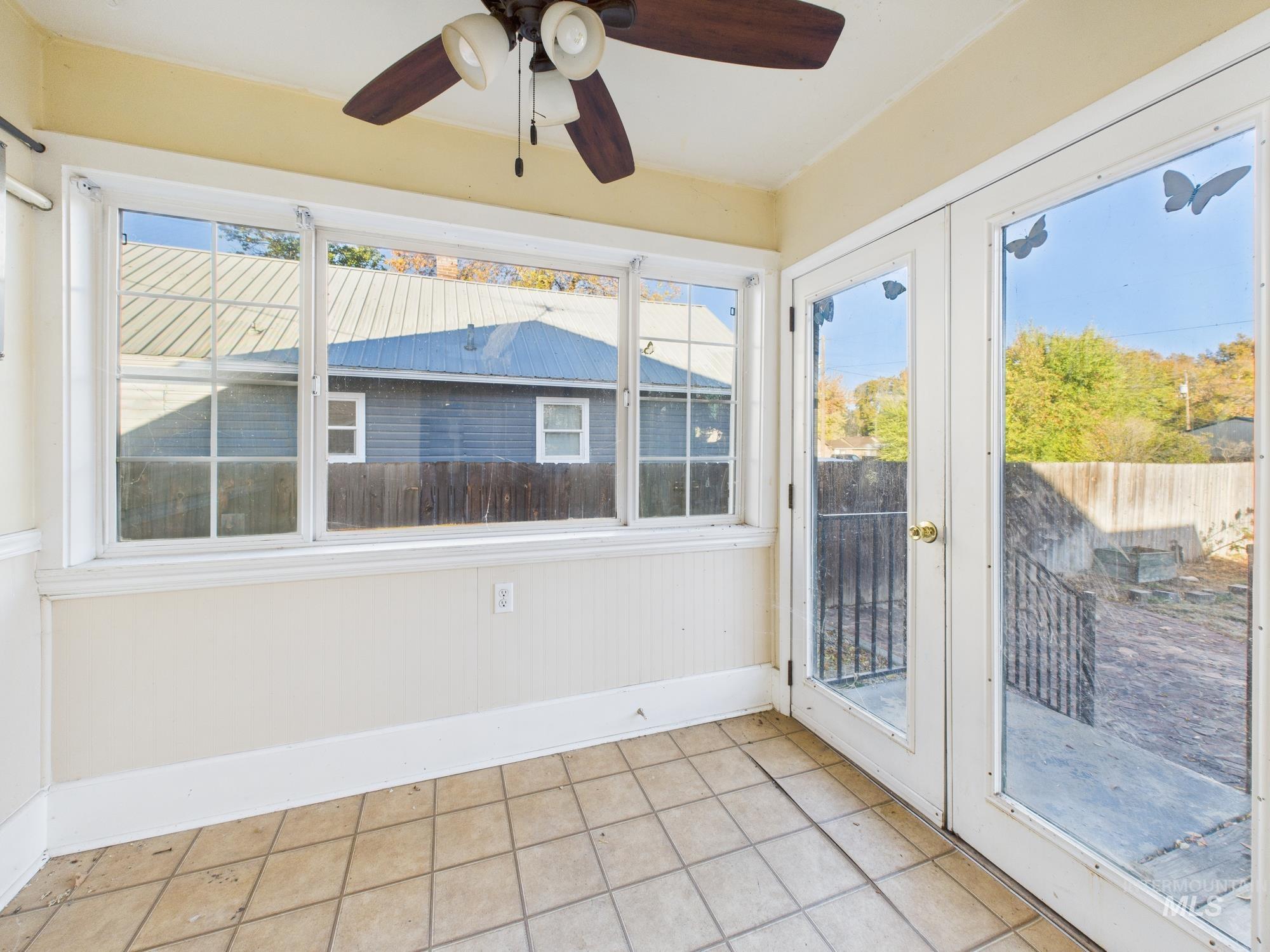 Unfurnished sunroom with french doors and tile patterned floors