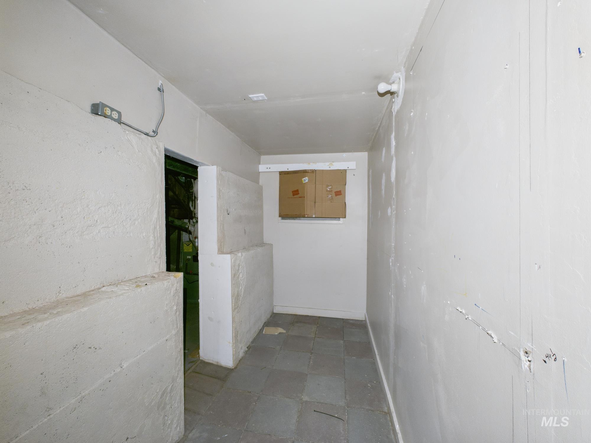 Corridor featuring stone finish floors