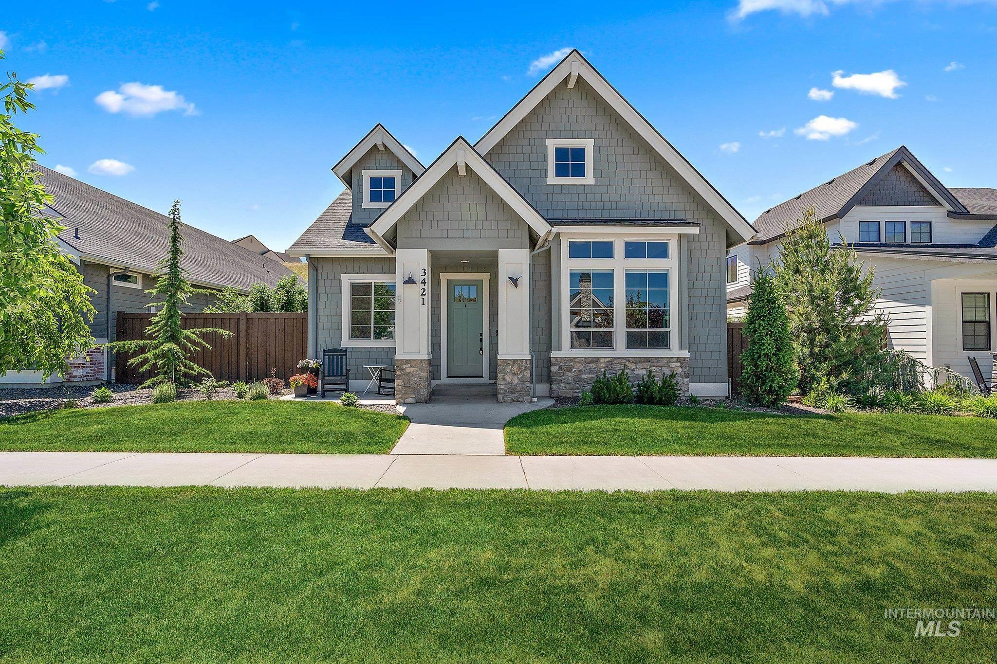 Craftsman-style house with stone siding and roof with shingles