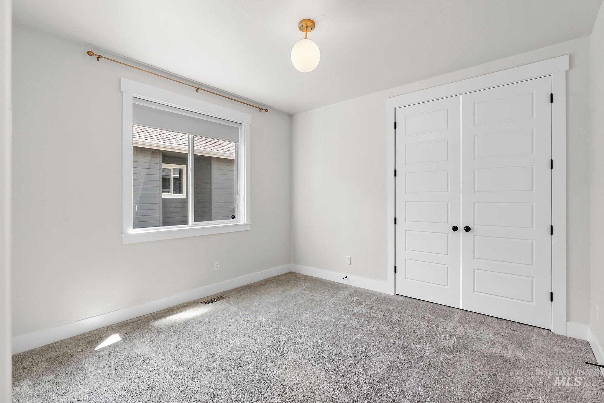 Unfurnished bedroom with carpet and a closet