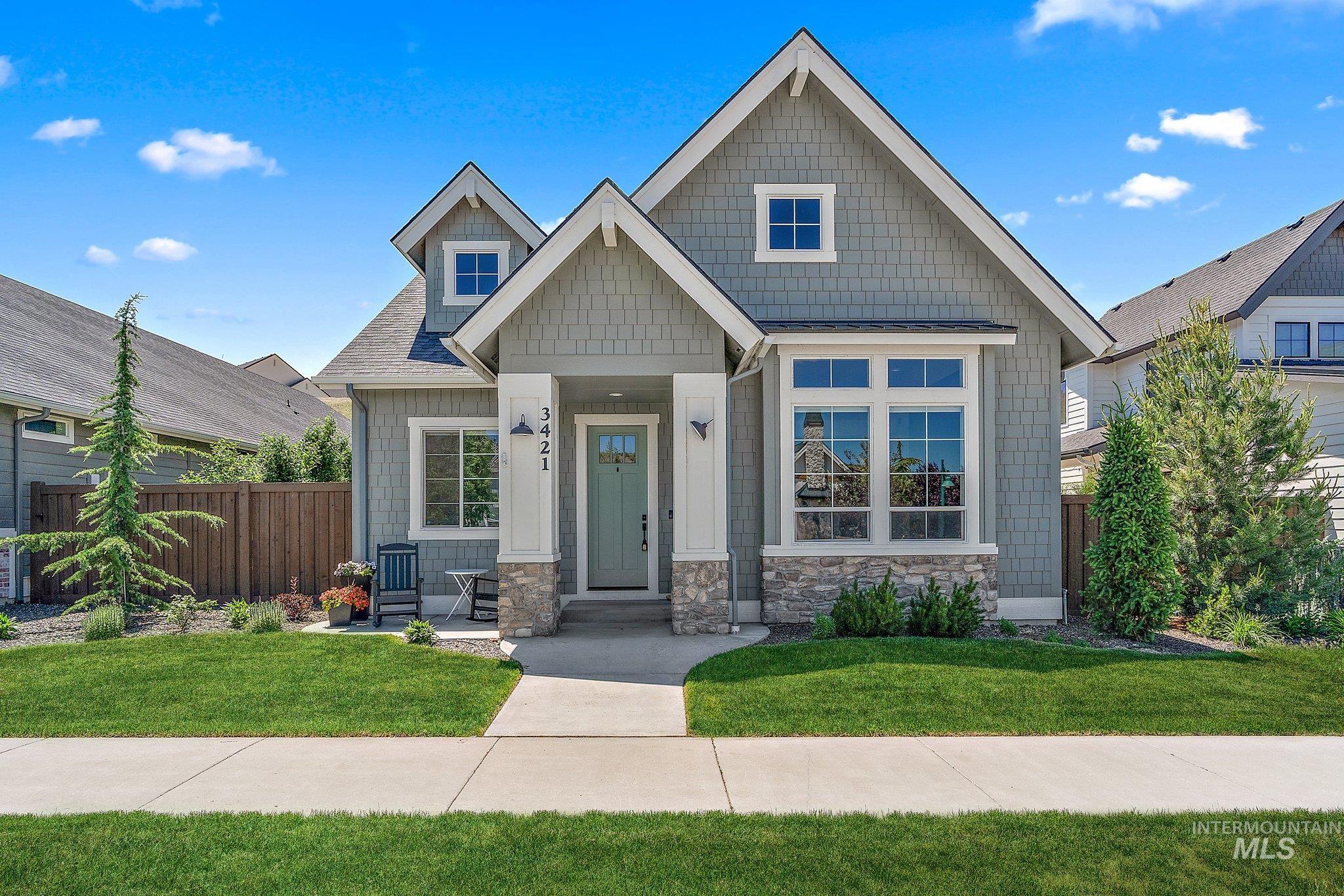 Craftsman house featuring roof with shingles and stone siding