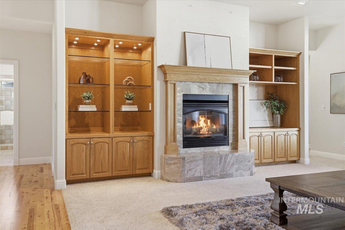 Living area featuring a premium fireplace and built in shelves