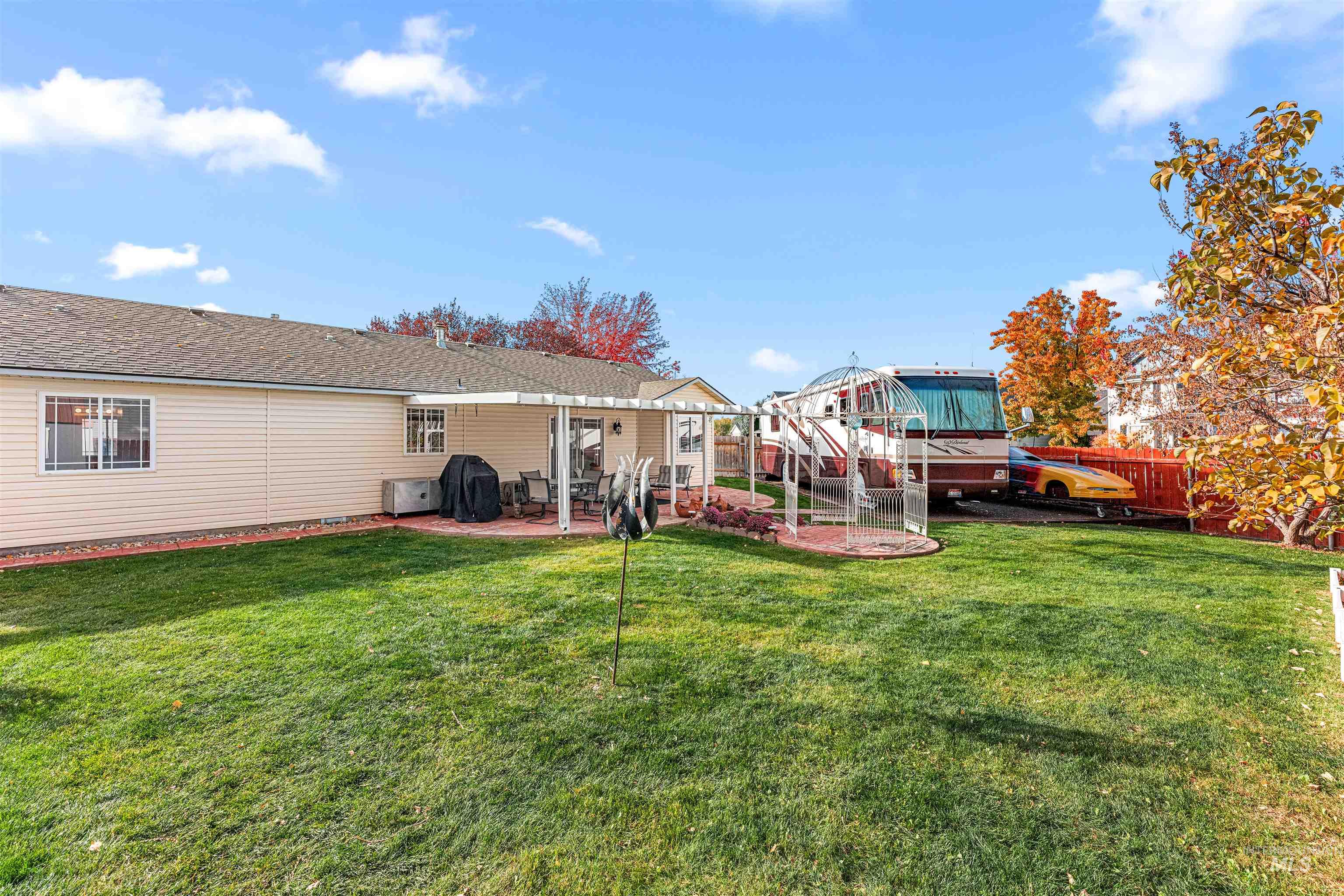 Back of property featuring a patio and a shingled roof
