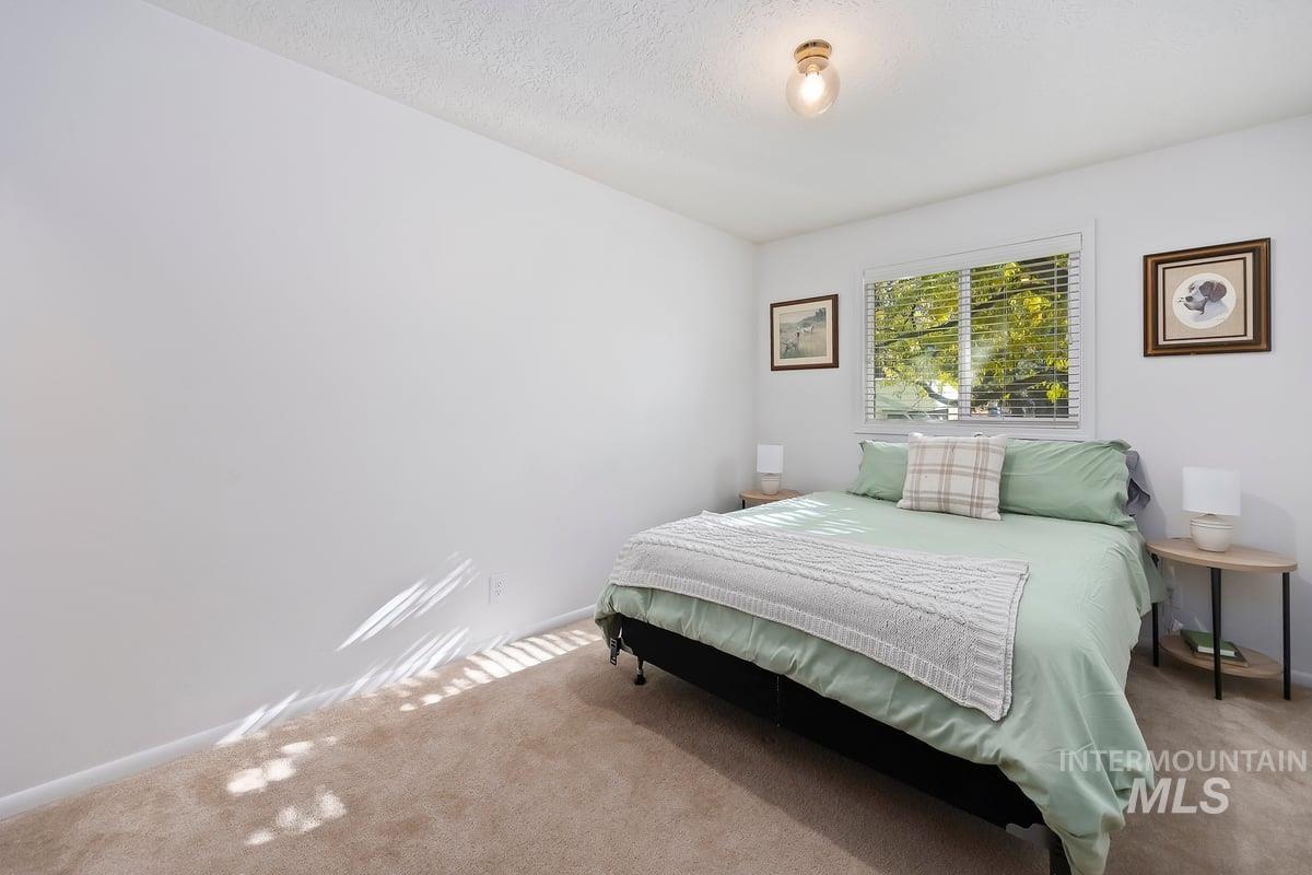 Bedroom with carpet flooring and a textured ceiling