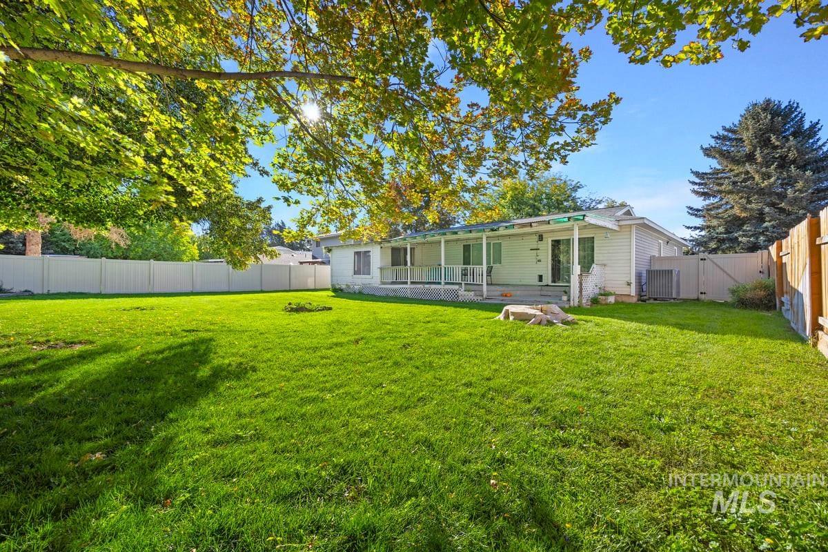 Rear view of property with a fenced backyard and a gate