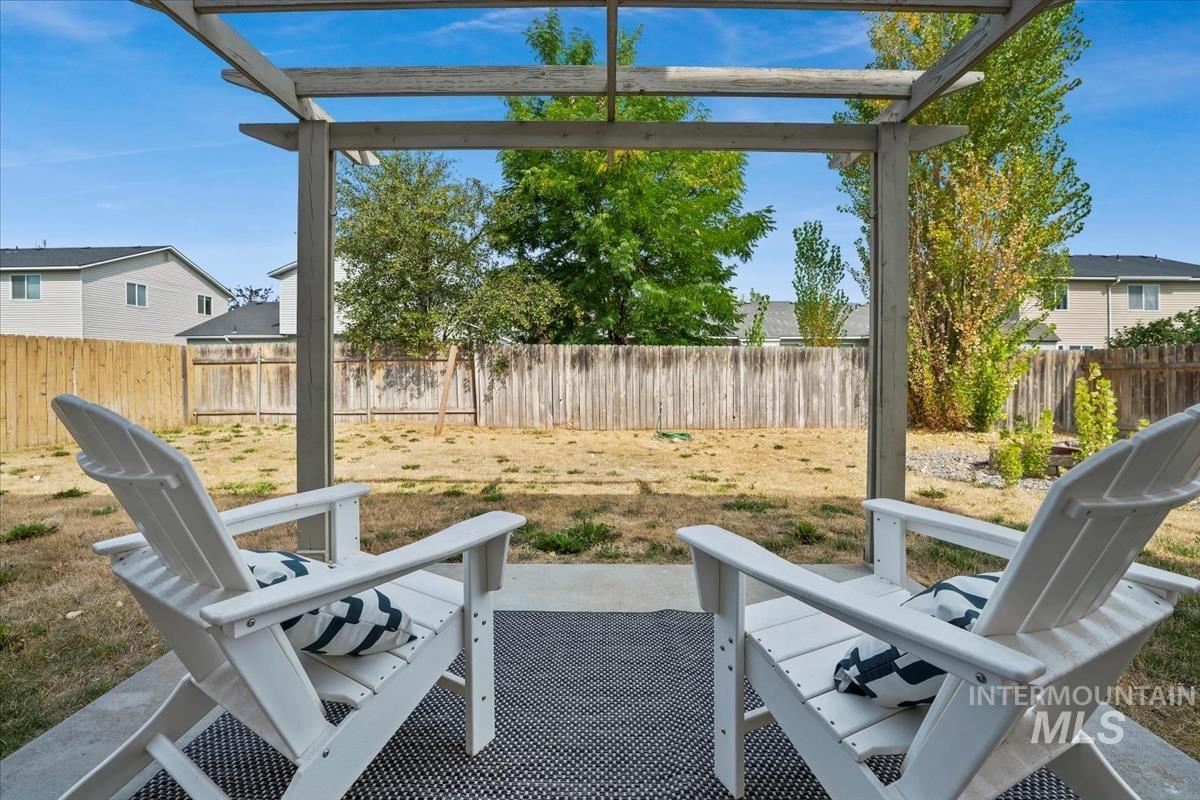 Fenced backyard featuring a pergola and a patio area
