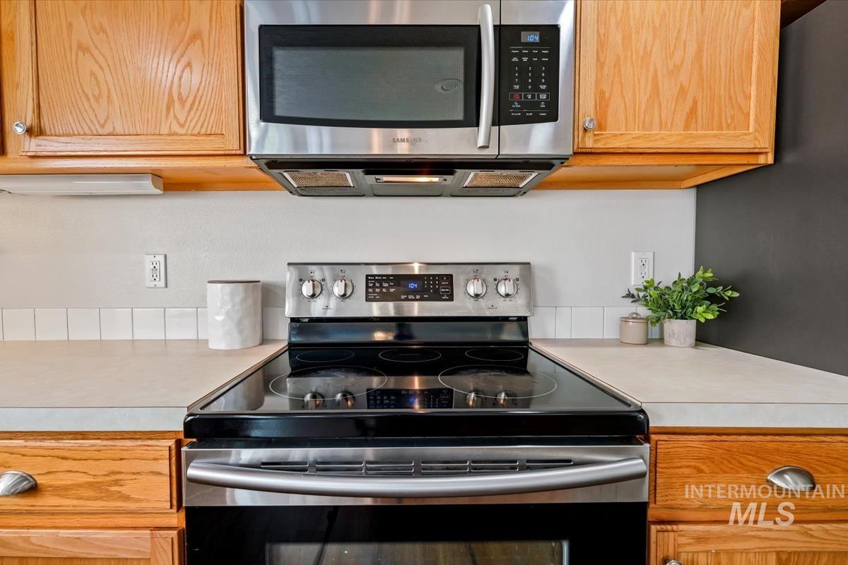 Kitchen featuring stainless steel appliances and light countertops