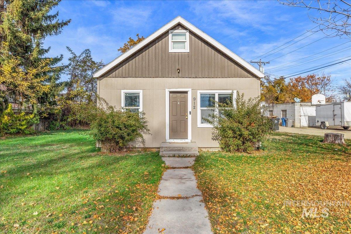 Bungalow-style house with a front yard