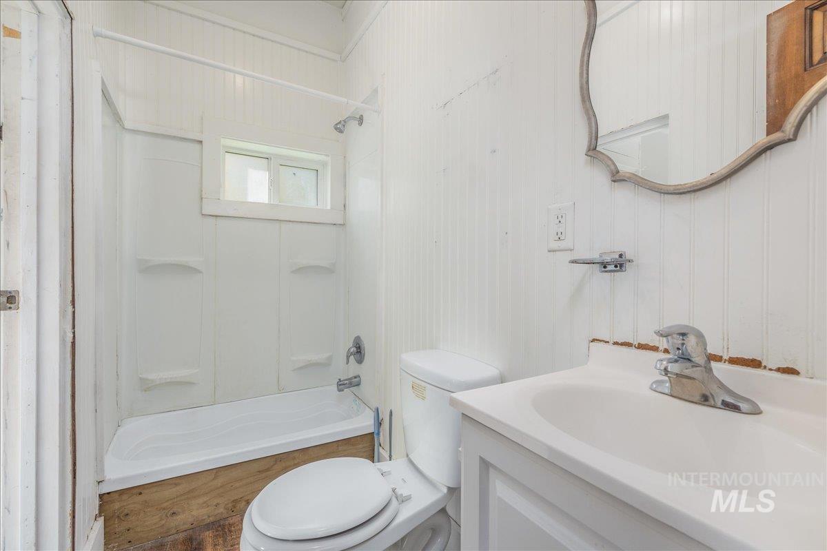 Bathroom featuring vanity and washtub / shower combination