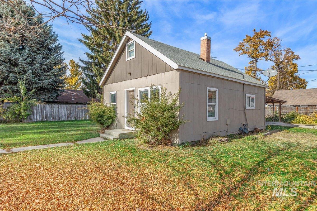 View of side of home with a chimney