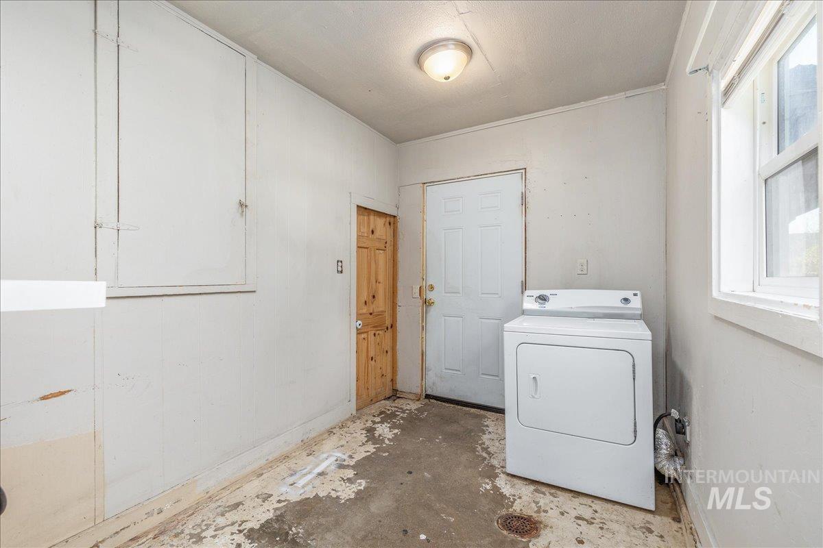 Laundry room featuring washer / dryer and concrete floors