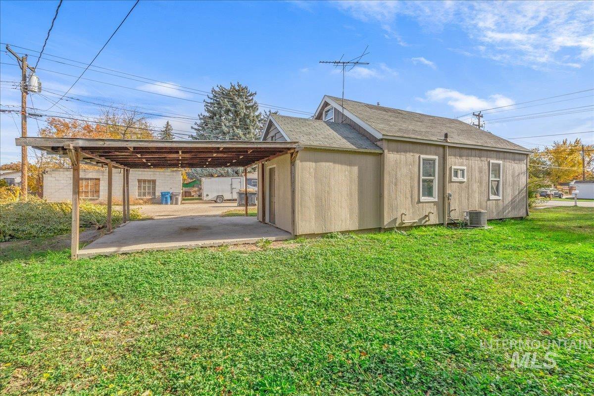 Rear view of house with a yard and a patio area