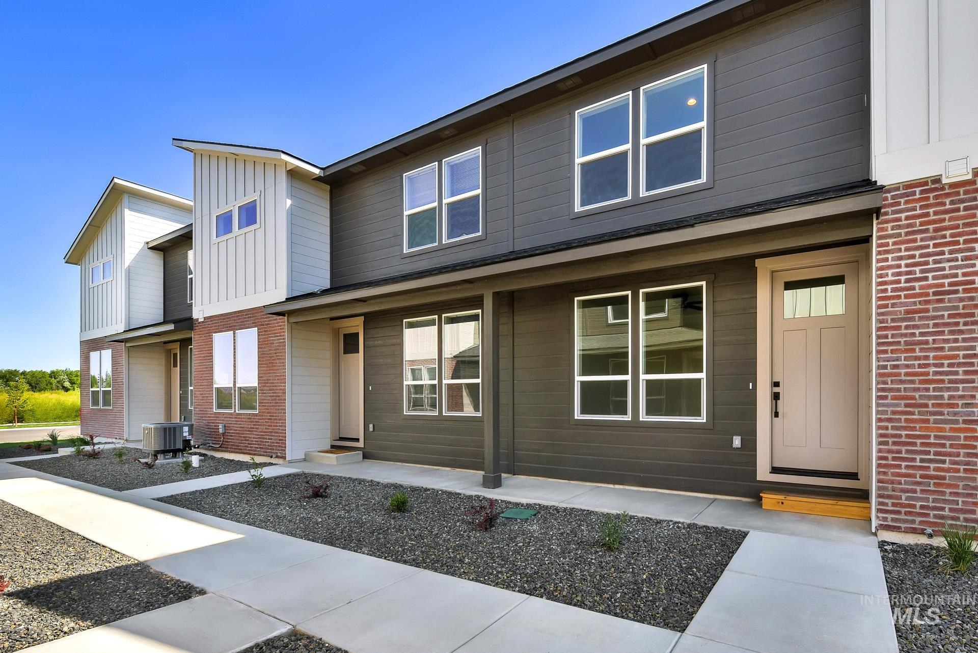 Modern home with brick siding and board and batten siding