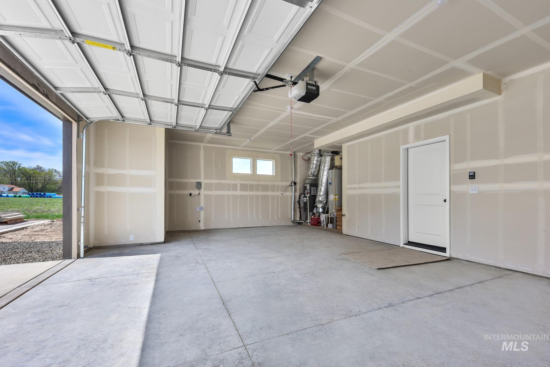 Garage with heating unit, a garage door opener, and water heater