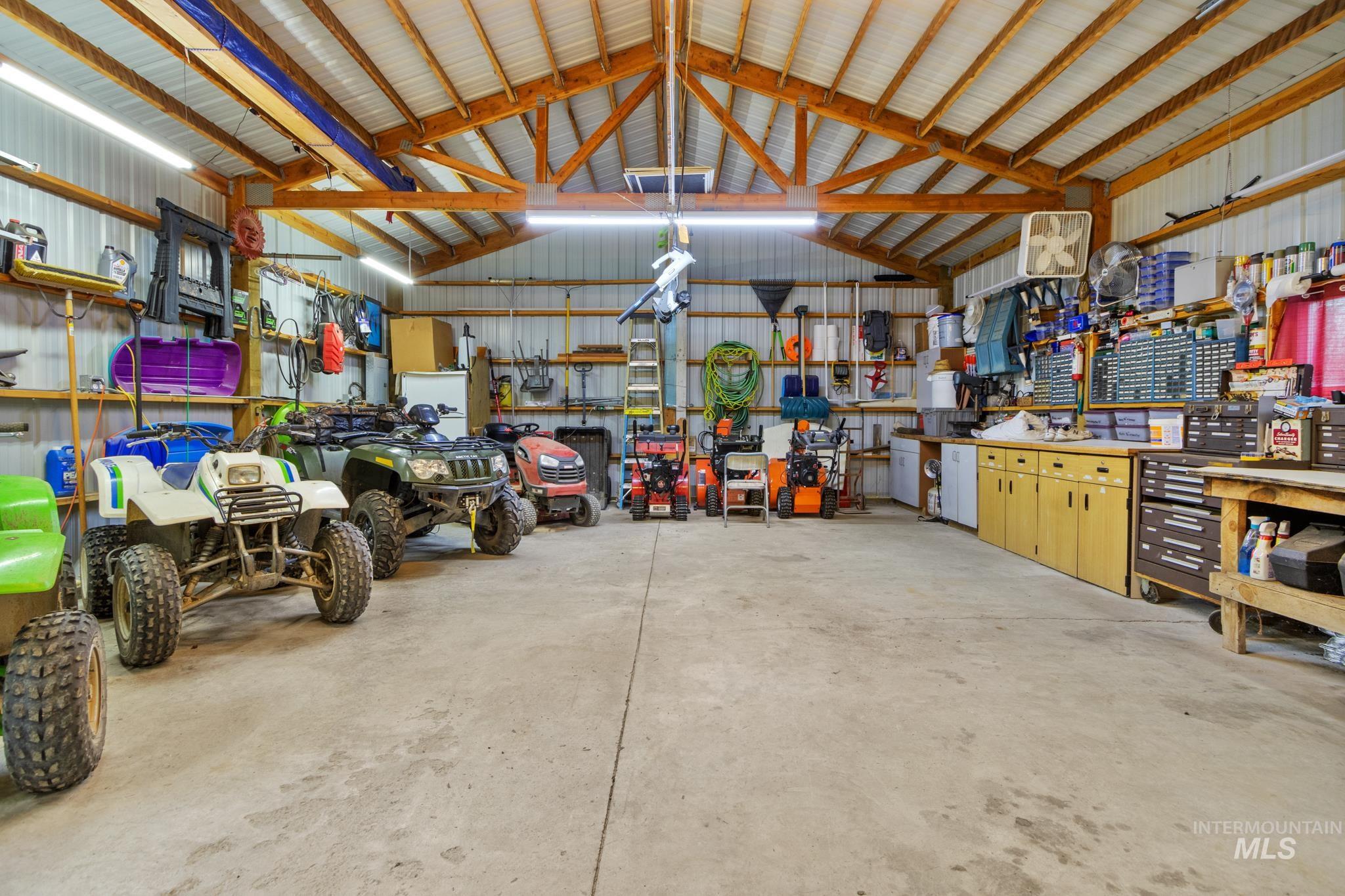 Garage featuring a workshop area and metal wall