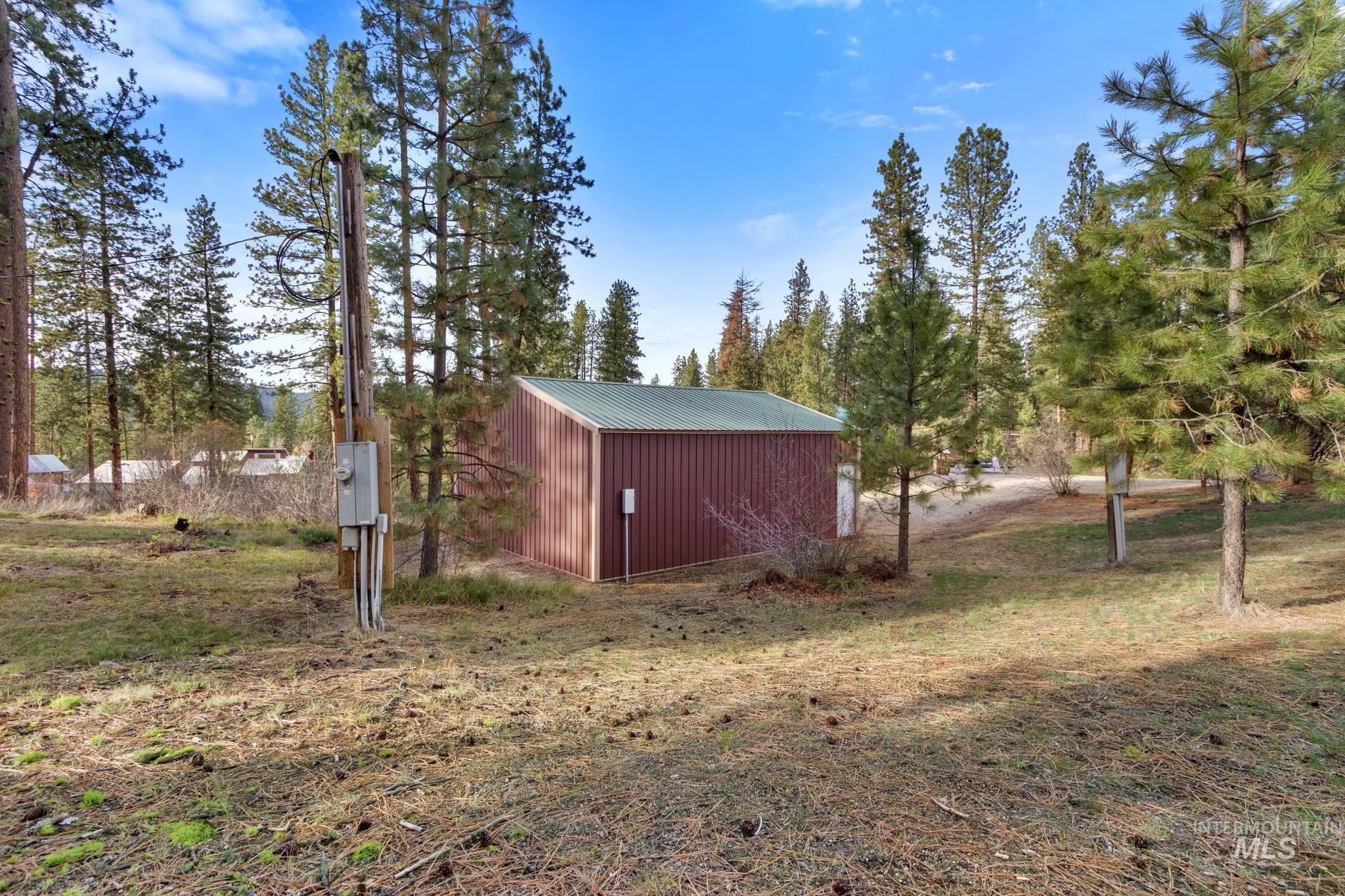 View of yard featuring an outbuilding and view of wooded area