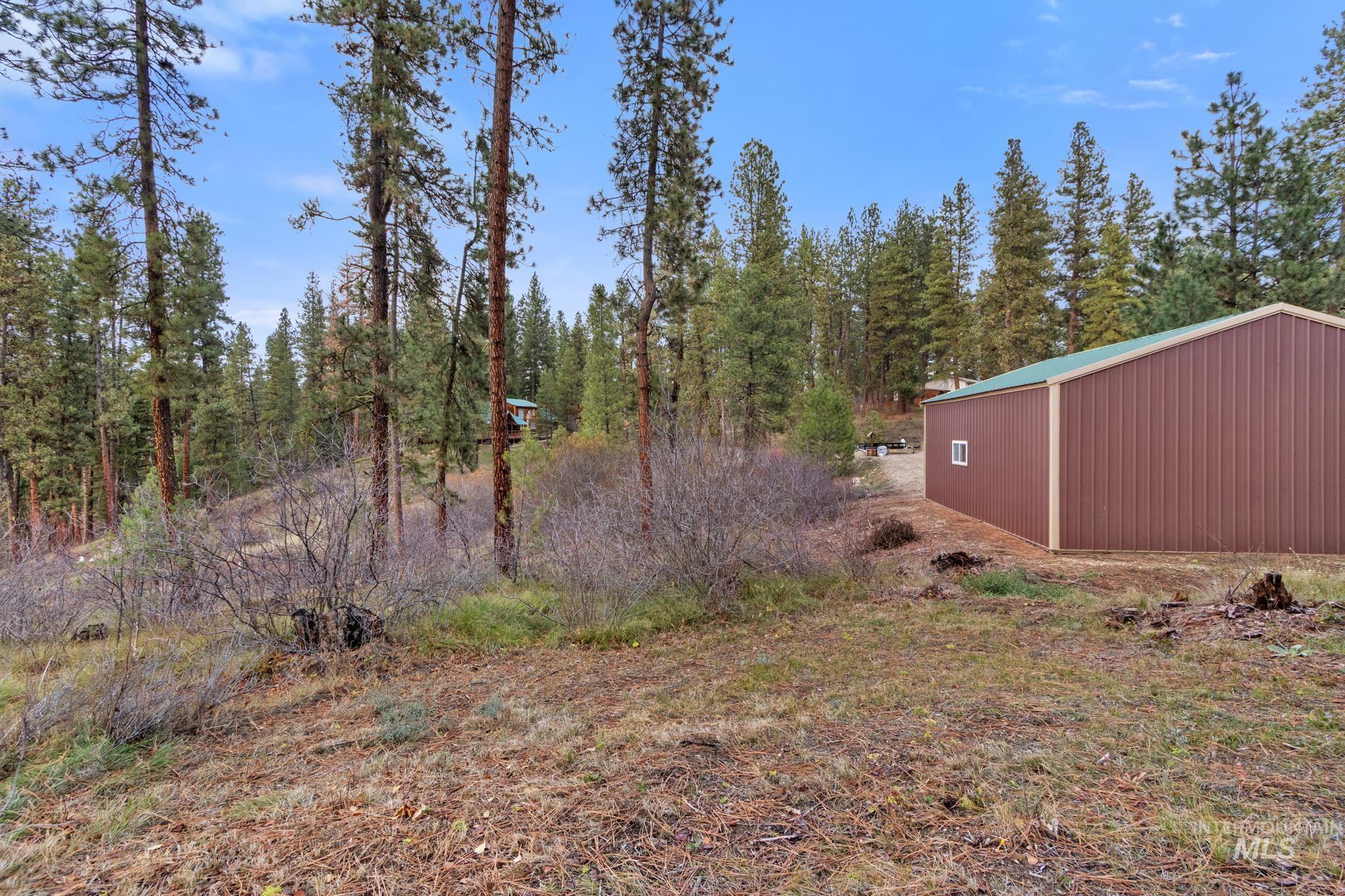 View of yard with a pole building and an outbuilding