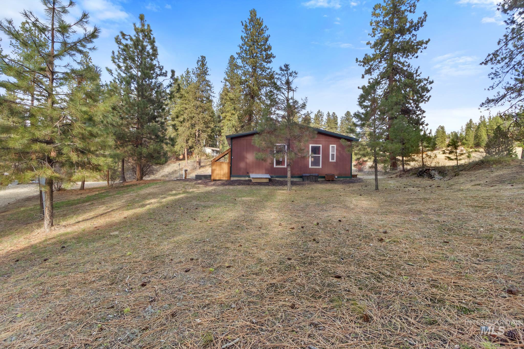 View of property exterior featuring a lawn
