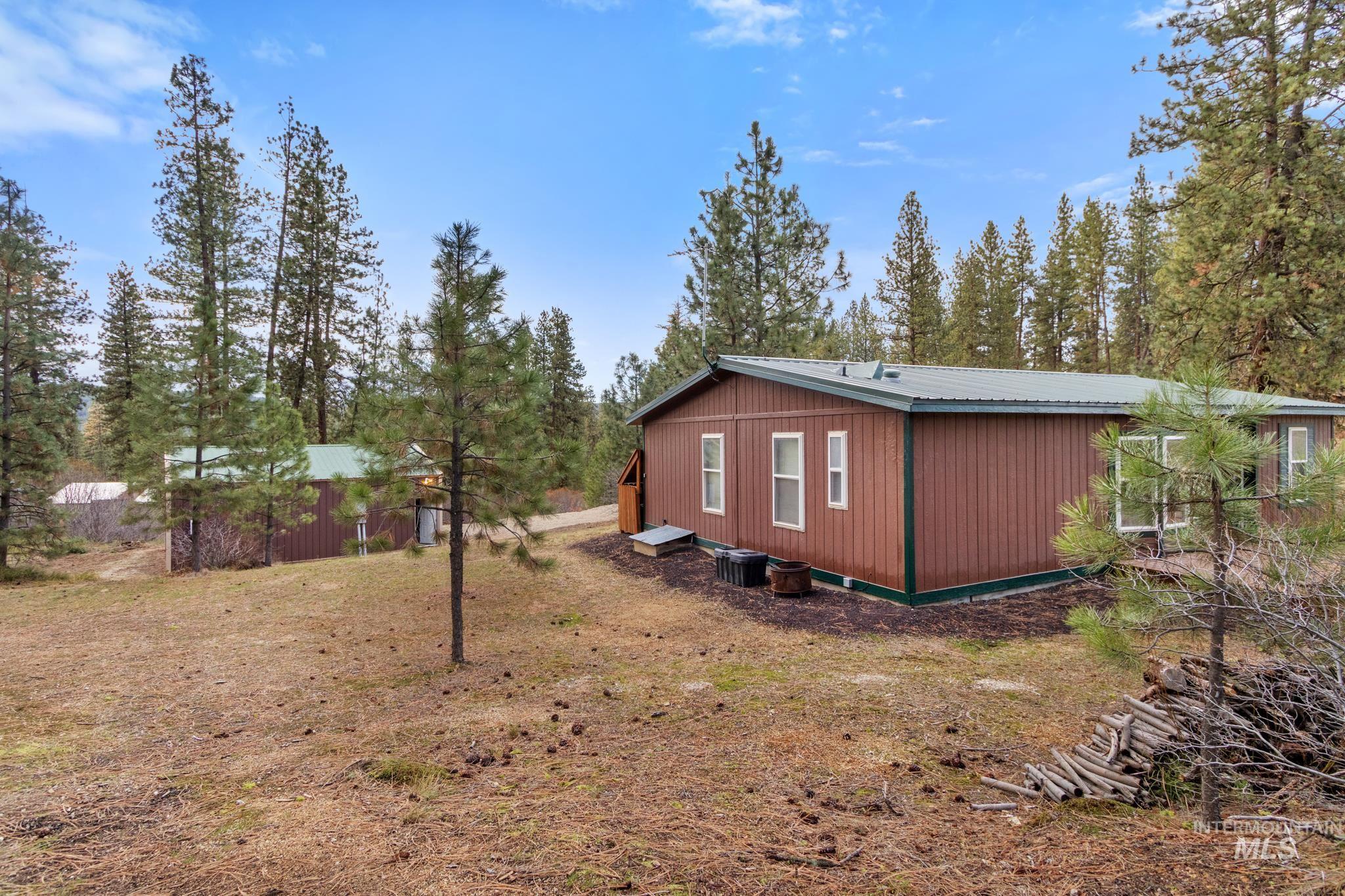 View of home's exterior featuring a metal roof and a central air condition unit