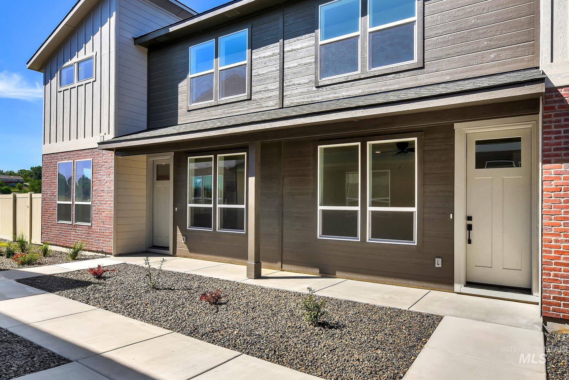 Doorway to property with brick siding and board and batten siding