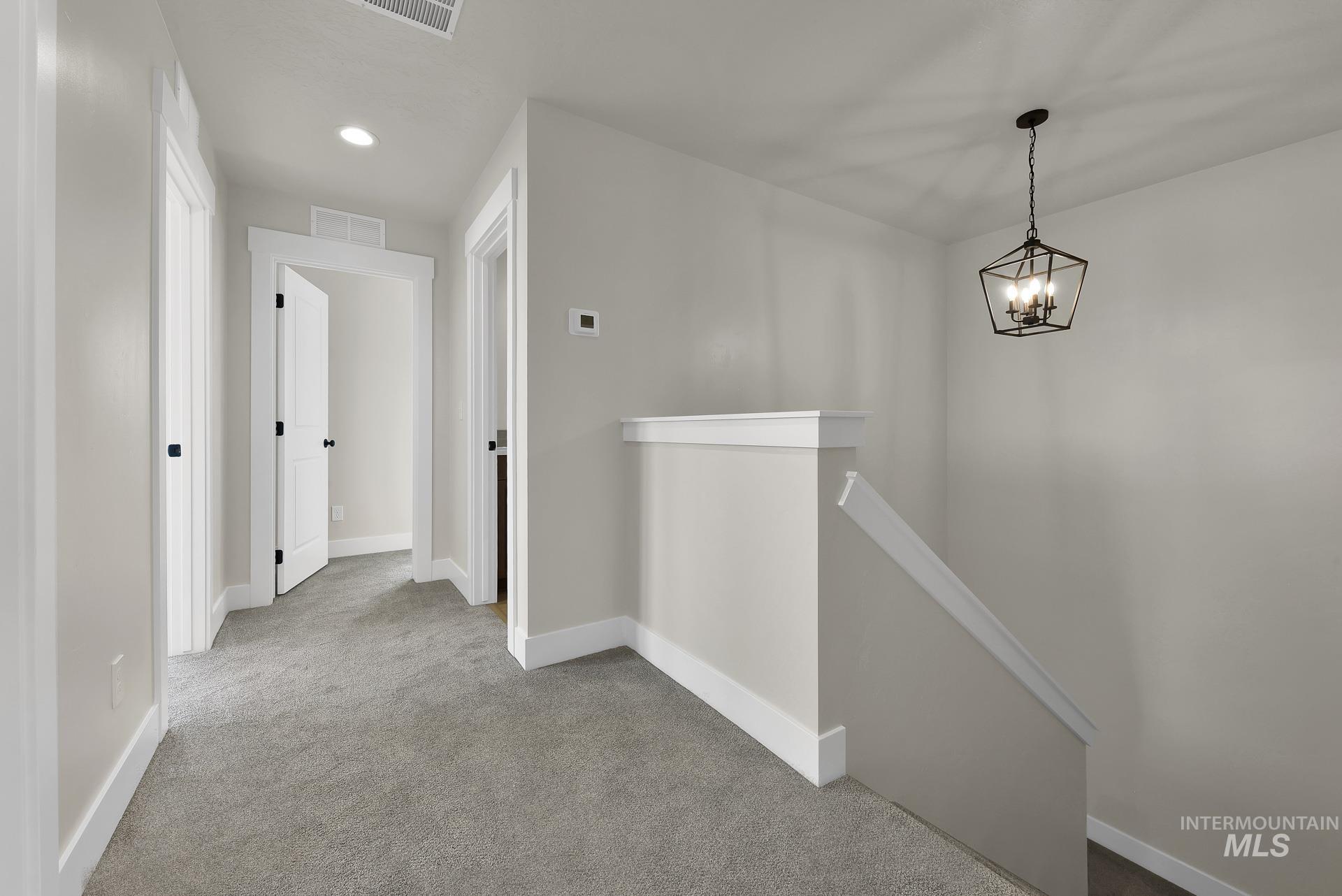 Corridor featuring an upstairs landing, carpet flooring, and recessed lighting